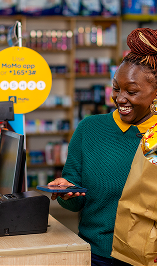 Lady with Groceries Paying with MoMo (Mobile)